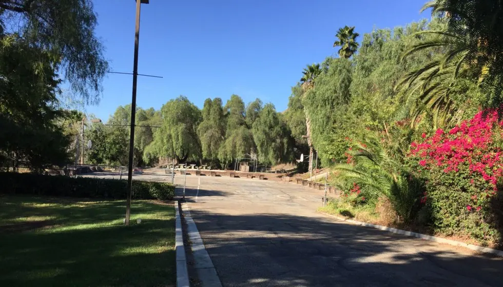 Tree-lined road and parking area near the Brea, California retreat venue